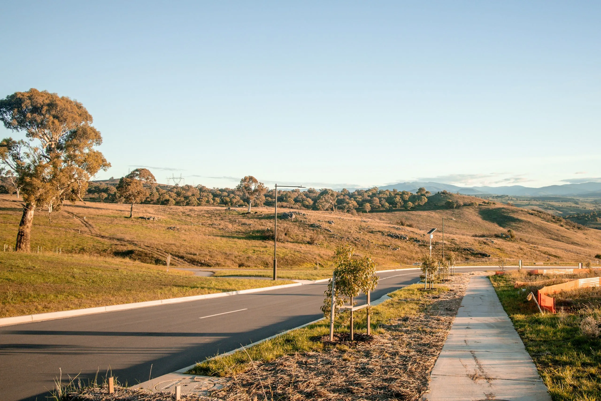 Quiet road and footpath through open country in early morning light